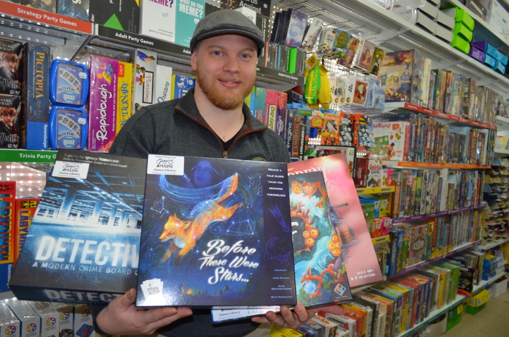 Justin Hallam-Stephens is pictured with some of his new games.