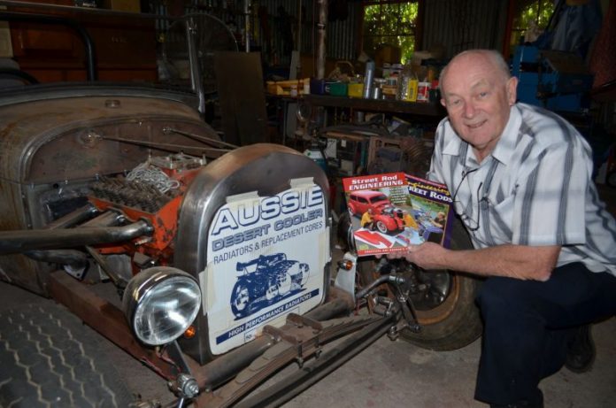 Graffiti Publications founder and local rodding enthusiast Larry O'Toole is pictured with his latest project - an A Model Ford Bucket - and the original and new editions of his engineering offering.