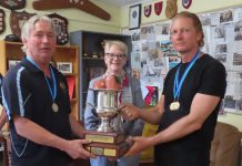 Rifle shooters return to the range Bendigo West MP and club patron Maree Edwards proudly presents the Don KR Castlemaine Cup to Castlemaine team members Alan Mills and Malcolm Laurence.