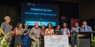 Merv Carr, daughter Katie Finlay and the elated team from Harcourt Organic Farming Co-Operative are proudly pictured receiving the 'Business of the Year' award last Thursday evening.