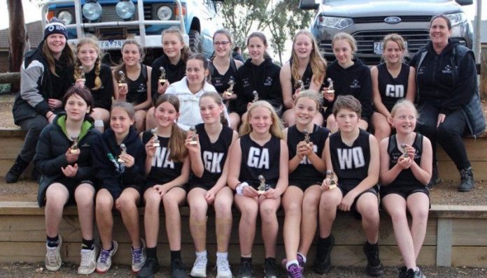 The Castlemaine 13s and 15s squads are proudly pictured with their runner-up trophies after a top weekend of netball action.