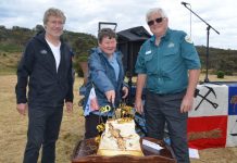 Celebrating 20 years Parks Victoria manager of heritage services Paul Roser, Chewton Domain Society member Marie Jones and Parks Victoria ranger Noel Muller cut the gold themed cake created by the Chewton Phoenix CWA.