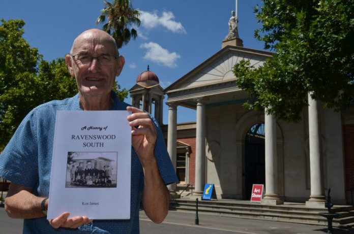 Historian Ken James is pictured with his latest book on Ravenswood South.