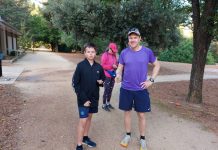 Castlemaine Parkrun milestones celebrated Sam and Luke, holding their ‘Milestones’, and about to run the ‘Tunnel of Love’.