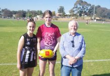 New chapter in local footy history Castlemaine Magpie Under 16 team member Kate Batchelor is pictured with Sandhurst Dragons footballer Ava Bibby and her grandfather Victor during their visit to Castlemaine last Sunday. Photo: Max Lesser.