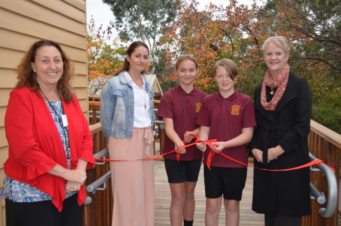 Bendigo West MP Maree Edwards unties the ribbon to official open the new look school with Principal Bernadette McKenna, School Council president Megan Butler and school captains Arkie and Zac.