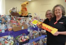 Raffle for the kids! Maxi IGA team members Min Daw and Elizabeth Retallick are pictured with some of the wonderful prizes to be won including a giant Lindt Bunny and one of two mega Toblerones!