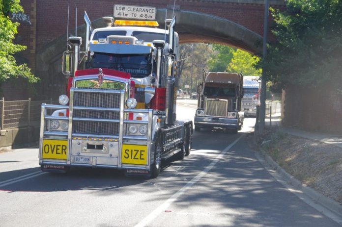 The bridge formerly had a 4.1m-4.8m limit. Trucks are pictured passing under the structure during the annual Truck Show convoy thorough Castlemaine.