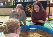 Jurassic wonders come to life Discovery Centre general manager Alissa van Soest and Lisa Chesters MP digging for fossils at one of the new experiences.