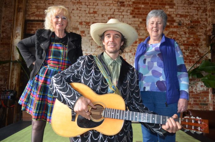 cElderAbuse281025 Sam Crassweller, talented local musician Archer and Helen Dewhurst invite the community to attend the Castlemaine Safe Space fundraiser on October 29. Photo: Lisa Dennis