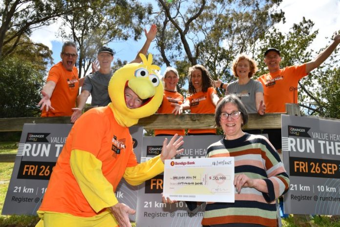 GL Run the Maine Committee Members and The Bird, proudly giving a $50,000 cheque to Dhelkaya Health's CEO, Sue Race.