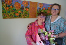An explosion of colour and pure joy Castlemaine artist Heather Murrowood is pictured with one of her mentors and support workers Sarah Wallace-Smith and one of her vibrant works.