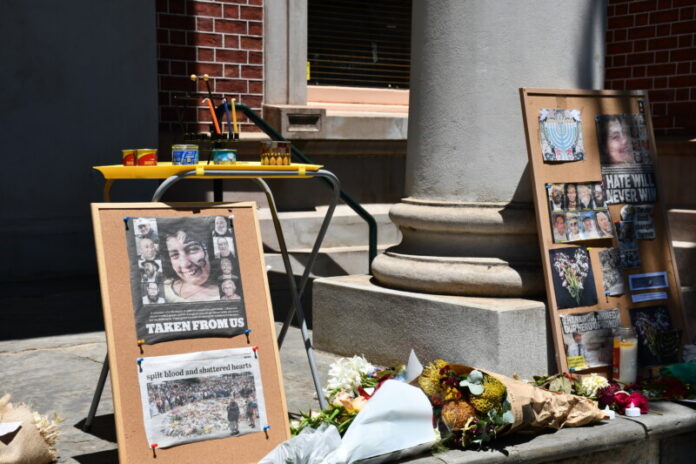 cvigil191225 Tributes were placed on the steps of the Market Building.