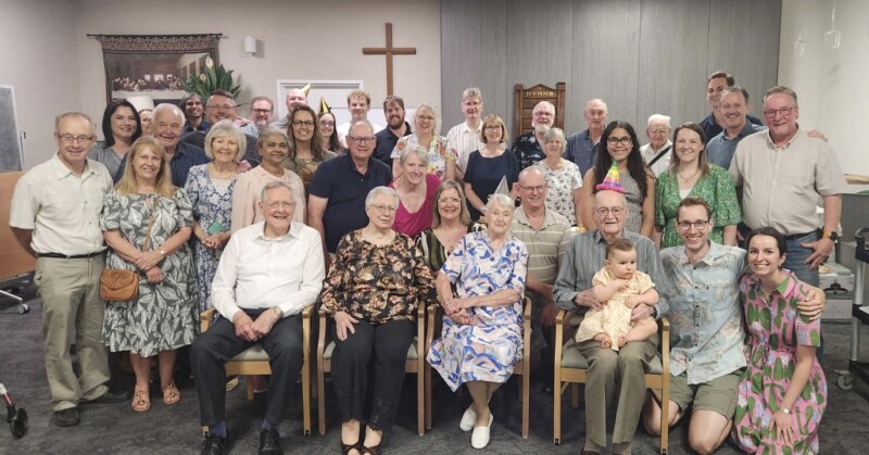 Malcolm is proudly pictured with his extended family and friends at Tuesday's celebration.