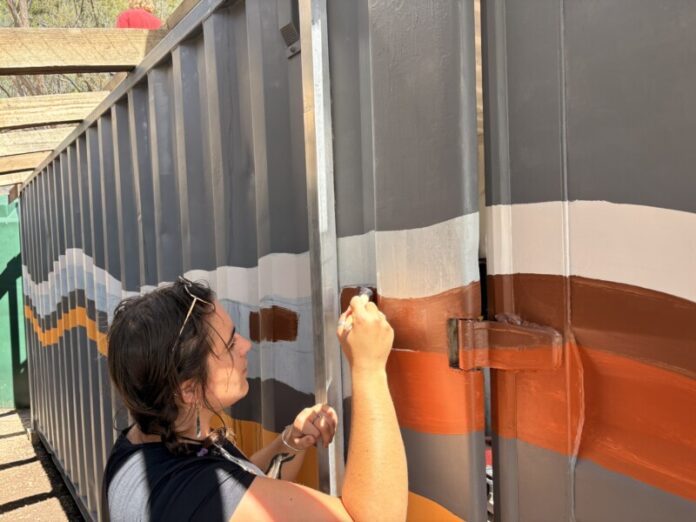 Grace Coff works to create the new mural.