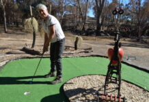 Woop Woop Mini Golf & Sculpture Gardens owner Judy Gleeson is pictured on one of the holes of the newly completed mini golf course just metres from the burnt out creek bed.