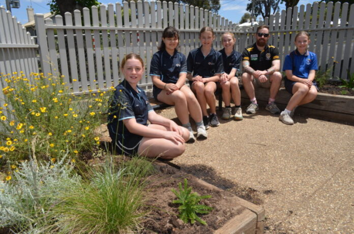 Olive, Ari, Elsa, Winnie, teacher Daniel O'Halloran and Molly are pictured in the newly planted Native Sensory Garden.