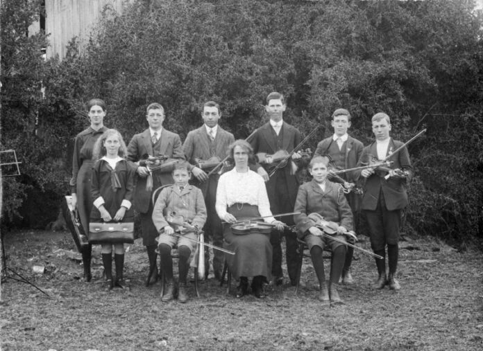 Renowned local music teacher Miss Rose McDonald with her nine successful students following the 1914 London College of Music violin exams.