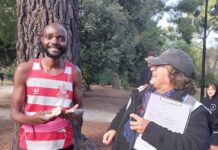 Reunion and celebration at Parkrun Adronis receiving his milestone momento from Run Director Jane Harding.