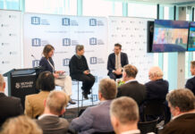 Making climate and energy policy work for all Australians Thom Woodroofe with Christiana Figueres, the former UN climate chief and Kevin Rudd and Malcolm Turnbull (on screen) during the Melbourne launch of his book.