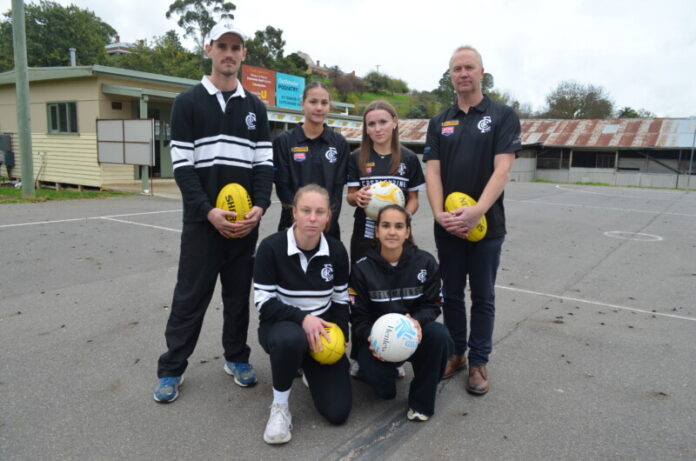 Castlemaine Football Netball Club Senior Coach Bailey Henderson, netballers Ellie Clifford and Ella Rixon, President Tim Matheson, Women's footballer Tia Davidge and netballer Taleisha Ahmat say the Camp Reserve facilities are subpar, particularly the netball court pictured.