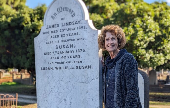Judith Hopkins is pictured at resting place of her ancestors and former saddlery owner James Lindsay, wife Susan and their children Susan, Willie and Susan at the Castlemaine Cemetery.
