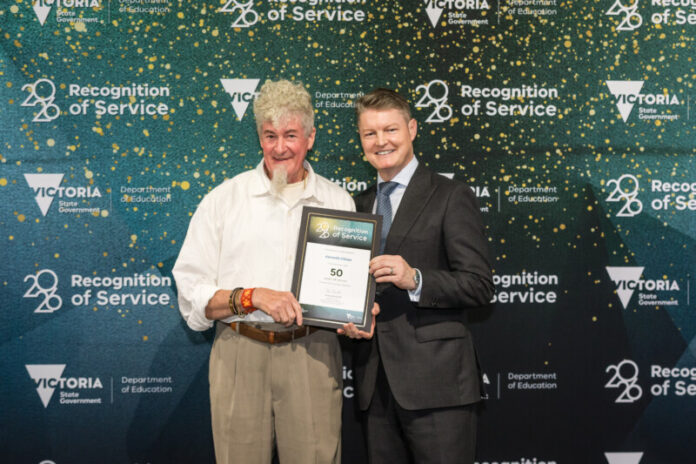 Ken proudly receives his 50 year recognition of service award.