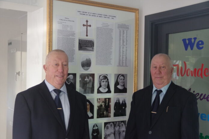 John and Bill Sikora are pictured with the donated frame which celebrates the history of the school.