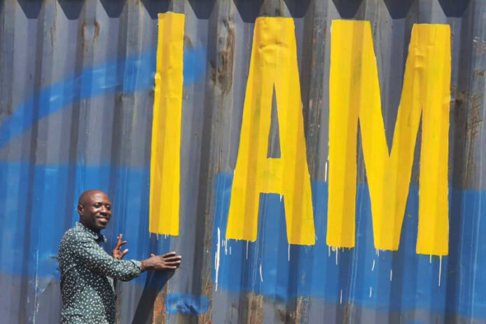 Ugandan Program Coordinator Henry with the container.