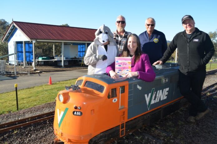 The Harcourt Valley Mouse (aka Loretta Rice), Harcourt Recovery Thinking Group for HADCRA (Harcourt & District Community Recovery Association) member Leigh Canet, Harcourt and District Lions Club treasurer Des Dooley, and VMR president Andrew Mierisch are pictured with author Rachel Vanstone and the new book. The launch event aims to raise funds to complete the community barbecue shelter, pictured at the rear. Photo: Lisa Dennis