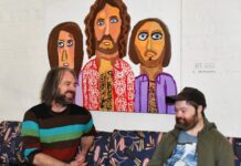 Larger-than-life Ned (right) with fellow artist Simon Dubbeld in front of his painting of the Bee Gees.