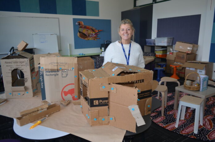 St Mary's principal Gemma Goodyear is pictured in one of their innovative classrooms surrounded by students' learning, including buildings constructed from cardboard boxes to demonstrate design skills and understandings.
