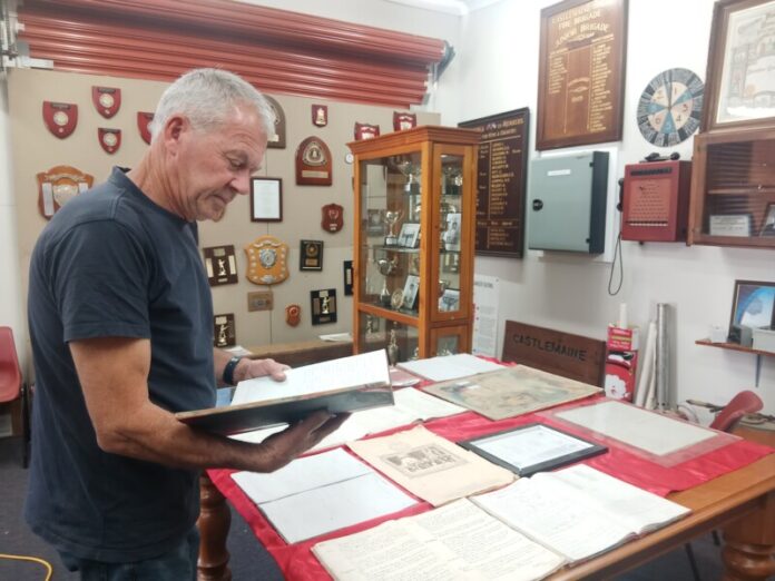 IMG_20251228_115718_173 erry Franklin (Castlemaine Fire Brigade Captain 2013-2025) shows one of the many Fire Books in the museum. Picture: Supplied