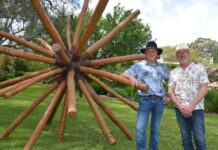 Behind the garden gate Mike Elith and Dean Swanson will be opening the gates to their stunning property 'Granite Garden' at Harcourt North. The couple are pictured with a sculpture by Mandurang artist Andrew Sardone. Photo: Lisa Dennis