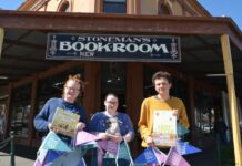 Show the love! Stoneman's Bookroom team members Leah, Paige and Arlo encourage you to join them in celebrating Love Your Book Shop Day. Photo: Lisa Dennis