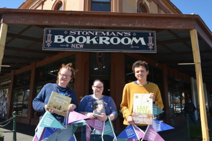 Stoneman's Bookroom team members Leah, Paige and Arlo encourage you to join them in celebrating Love Your Book Shop Day. Photo: Lisa Dennis