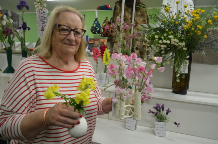 Show secretary Debbie Hamilton is pictured with some of the beautiful floral entries.